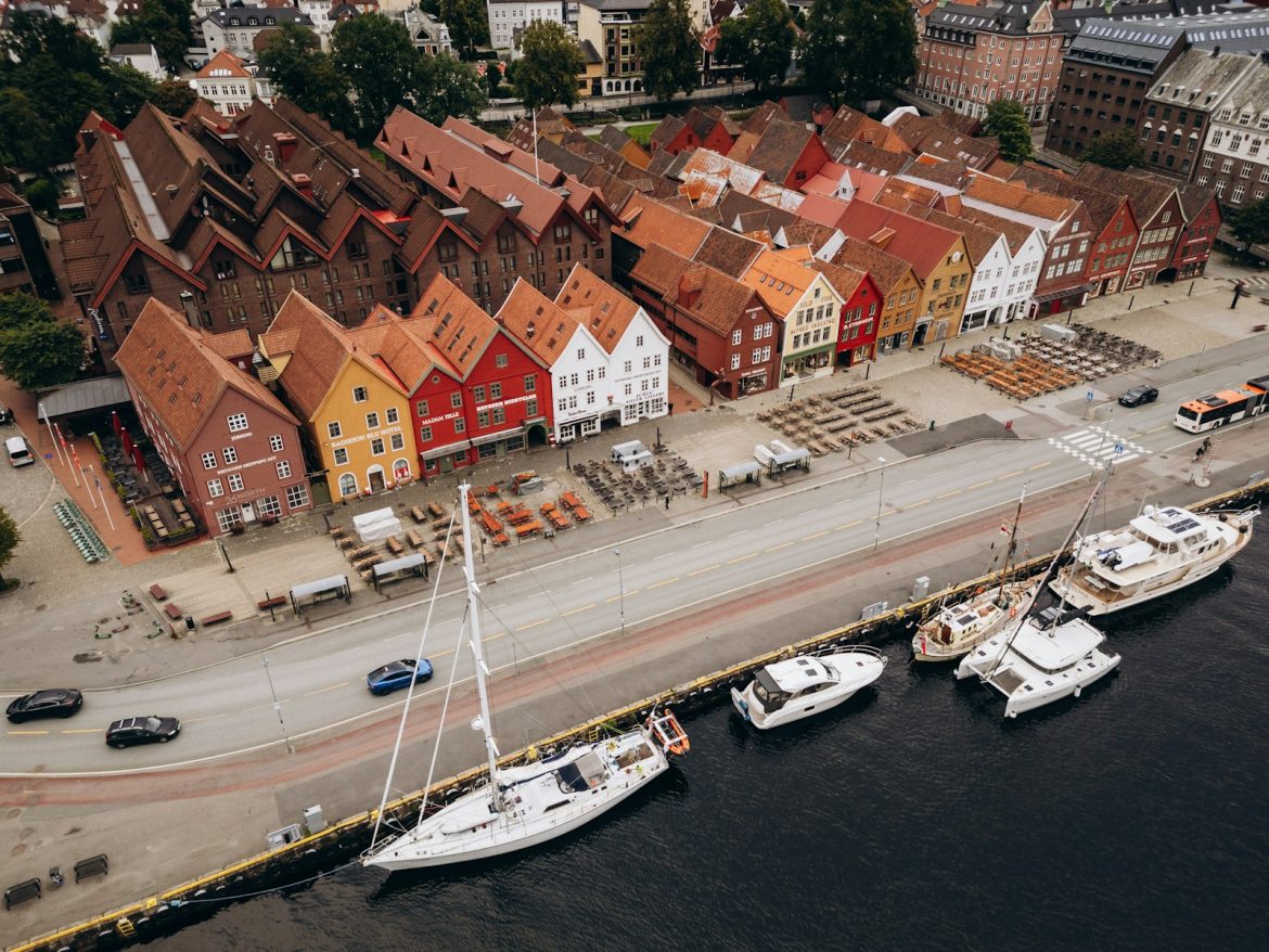 Colorful historic buildings line a waterfront with boats.